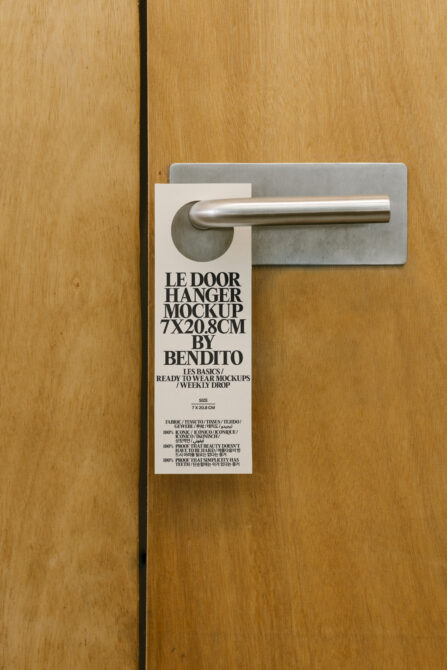 Door hanger mockup on a wooden door with metal handle. Ideal for graphic designers. Keywords: mockup, template, design asset, door hanger.