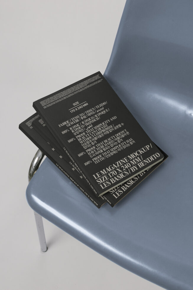 Magazine mockups on a blue chair, featuring black covers with white text. Ideal for designers seeking sleek and minimalistic design templates.