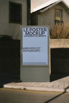 Light blue poster mockup with black typography on concrete street fixture