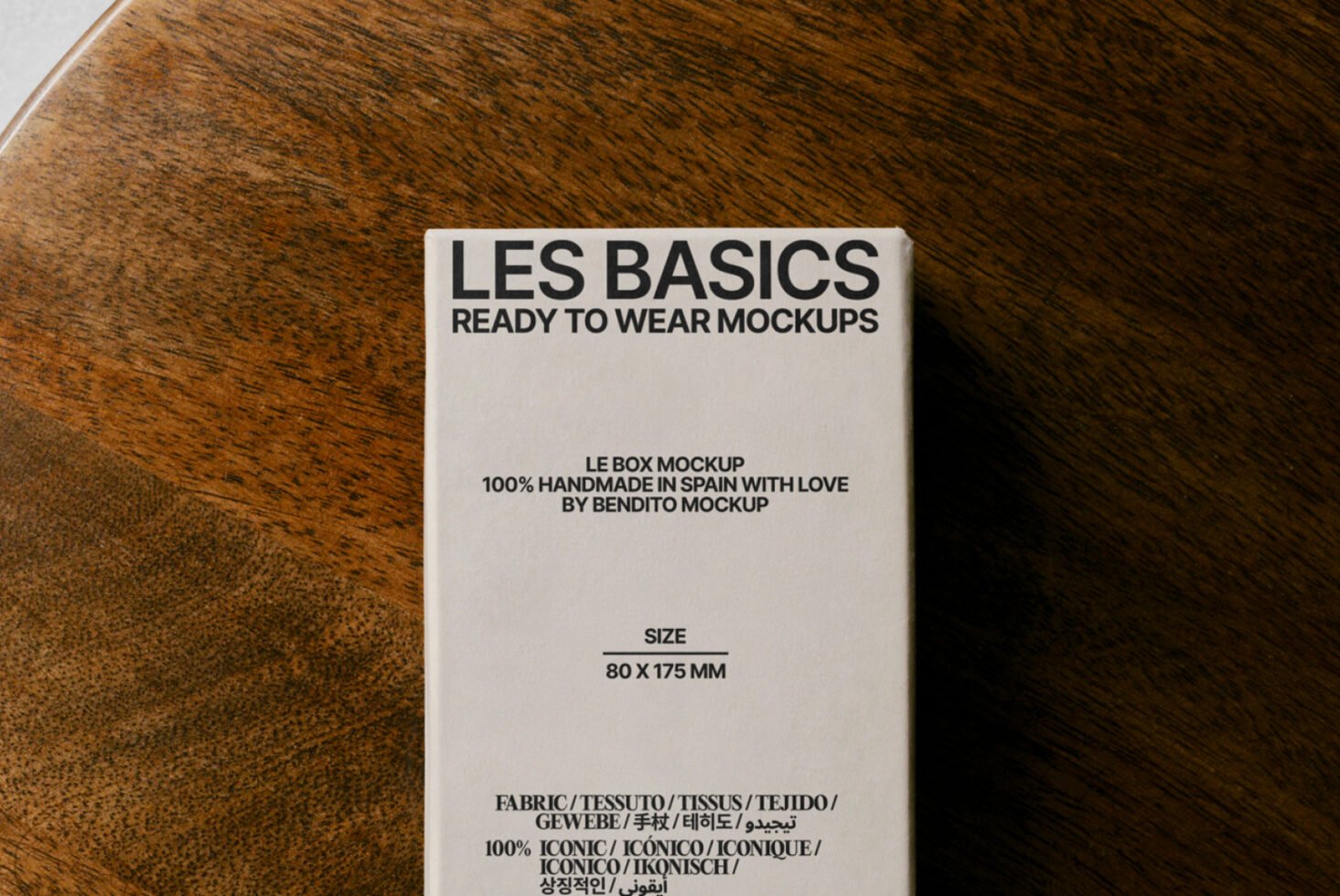 Box mockup on wooden surface showcasing clean typography design. Text reads Les Basics Ready to Wear Mockups. Ideal for product mockup presentations.