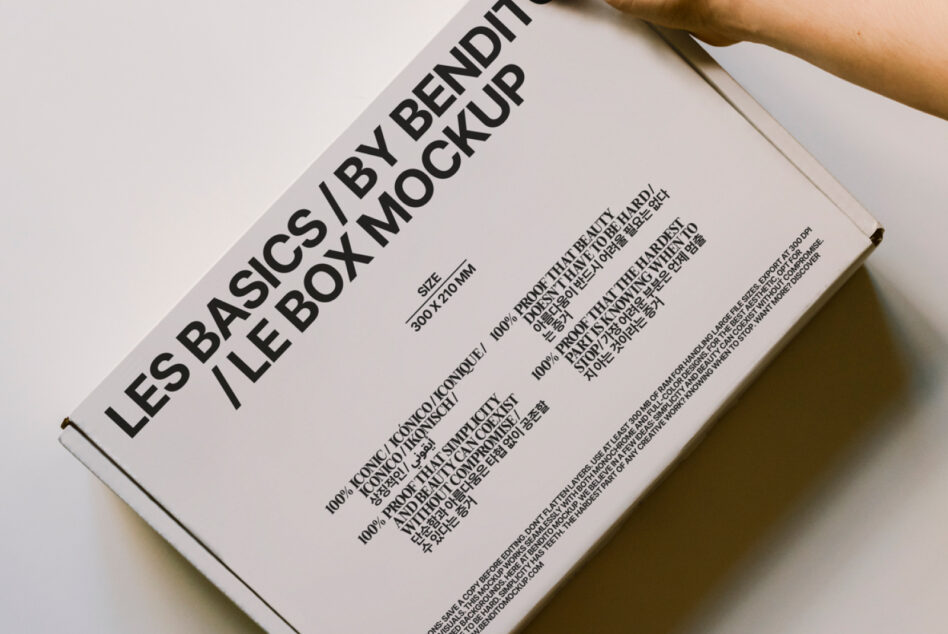 Overhead shot of white box mockup held in hands, showing angled perspective