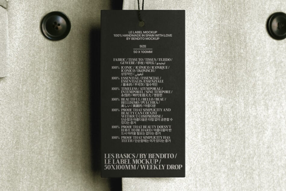 Dark hang tag with white text on cream fabric with black button details