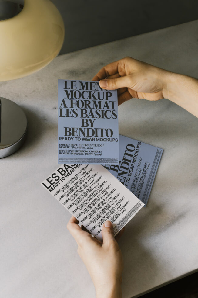 Hands holding typography design cards displaying mockup templates for branding. Ideal for designers seeking ready-to-use mockups and graphic resources.