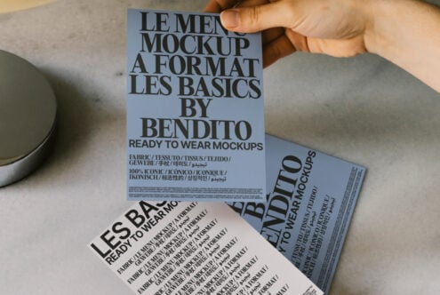 Hand holding fashion mockup card set with bold typography for designers. Ideal for showcasing ready-to-wear concepts. Mockups, design assets.