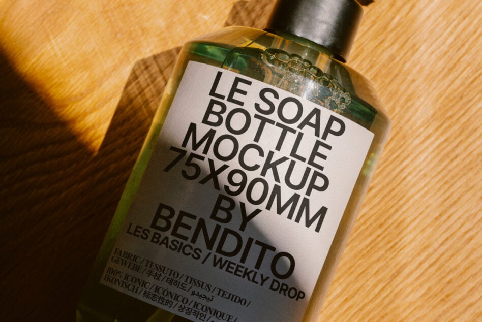Golden liquid soap bottle with white label on wooden surface
