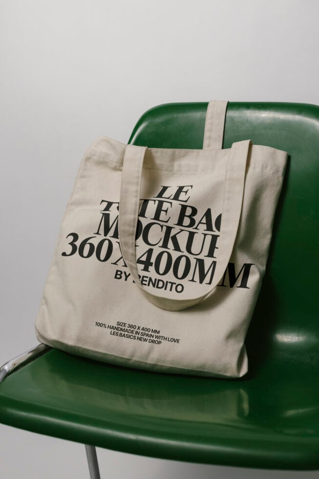 Tote bag mockup 360x400mm on green chair; ideal for showcasing branding designs; perfect for designers needing realistic canvas tote visuals.