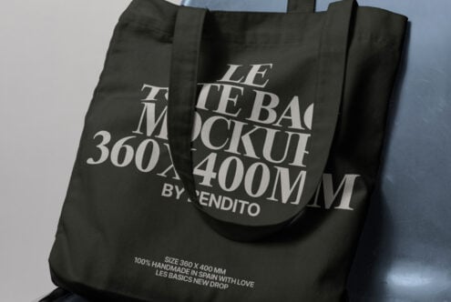 Tote bag mockup with white text on black fabric, showcasing typography design. Ideal for designers working on branding, packaging, and product displays.