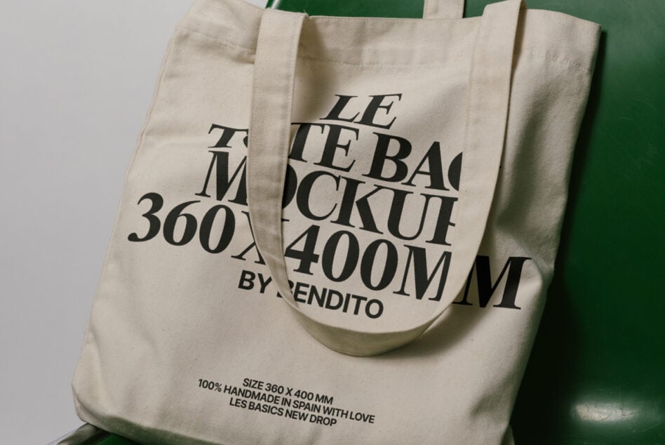 Cream canvas tote with layered serif lettering design on green seat