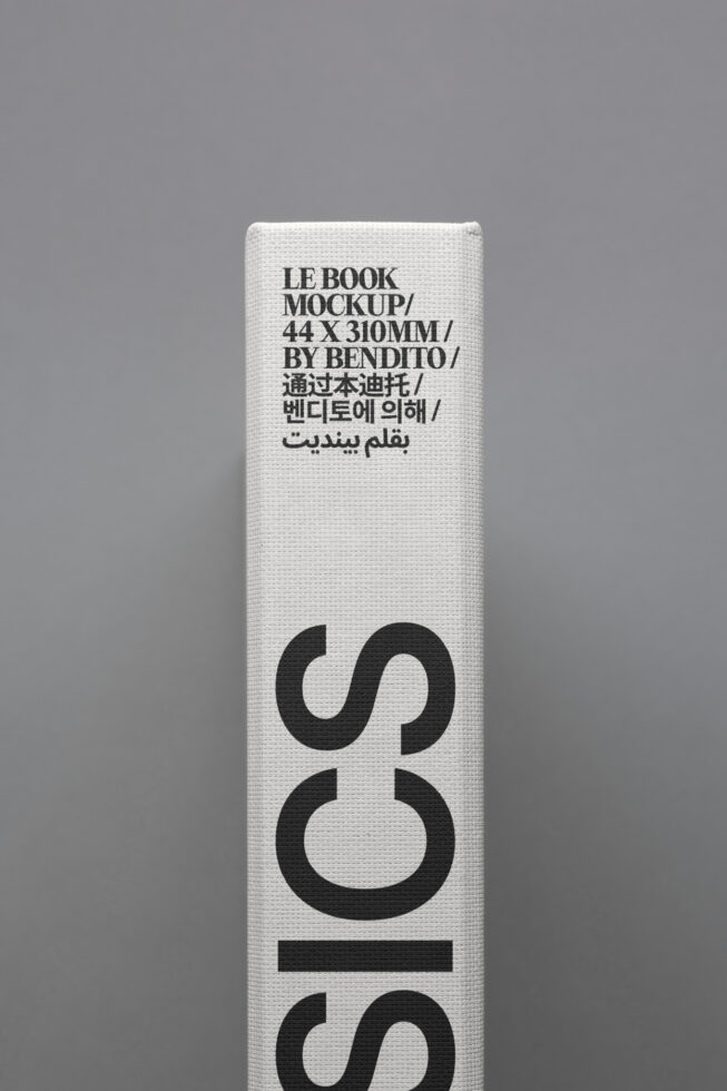 Book spine mockup with multilingual text in black on white canvas texture. Ideal for design templates, branding, print presentations, digital assets.