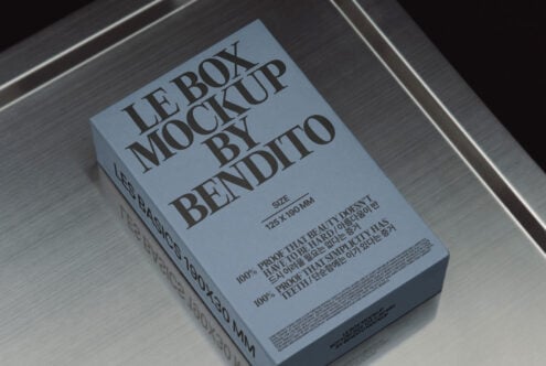 Blue box packaging mockup on metallic surface showcasing branding design. Perfect for designers seeking realistic presentation. Keywords: Box Mockup, Design.