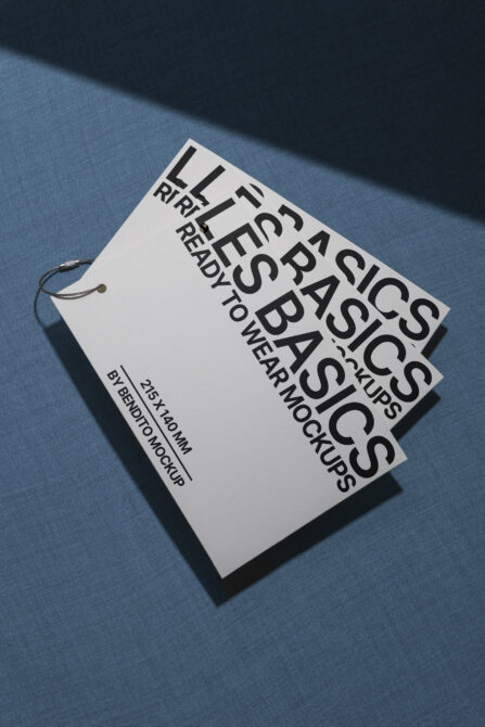 White hang tag mockup on blue fabric with string loop