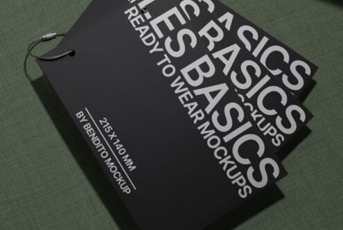 Black hang tag mockup angled on sage green fabric background