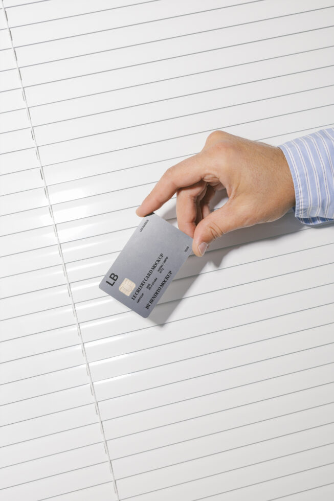 Hand holding a credit card mockup against a white background. Ideal for designers seeking professional, realistic presentation templates and graphic assets.