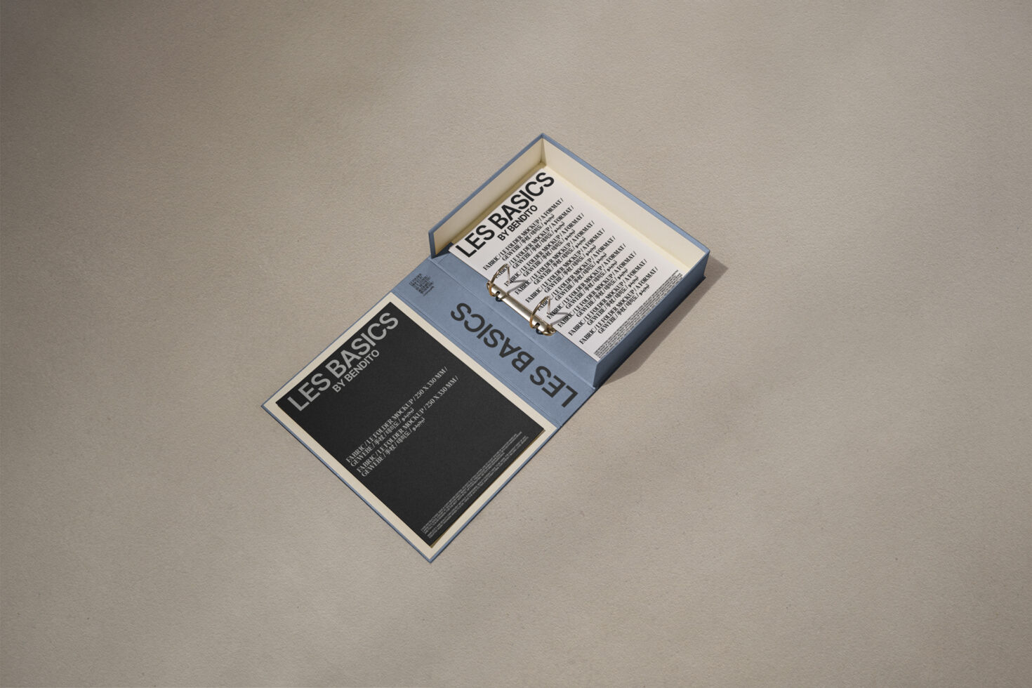 Open box with text on black and white sheets, titled Les Basics by Ibentojo. Perfect for designers seeking typography and layout inspiration.