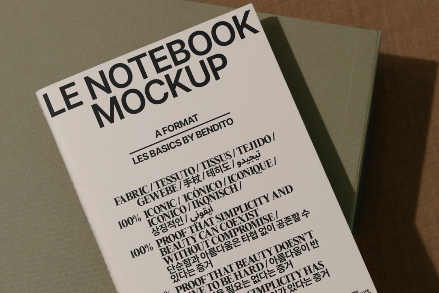 Notebook mockup featuring bold typography on a fabric cover suitable for graphic and template design. Ideal for design presentations and layouts.