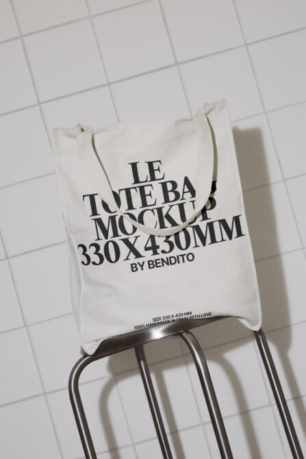 Natural linen tote bag mockup on metal stand with white tile background