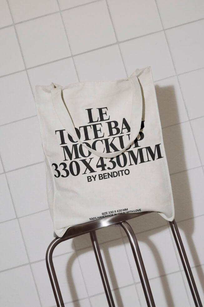 Tote bag mockup featuring 330x430mm dimensions, styled on a metal chair against a tiled background, ideal for showcasing tote bag designs