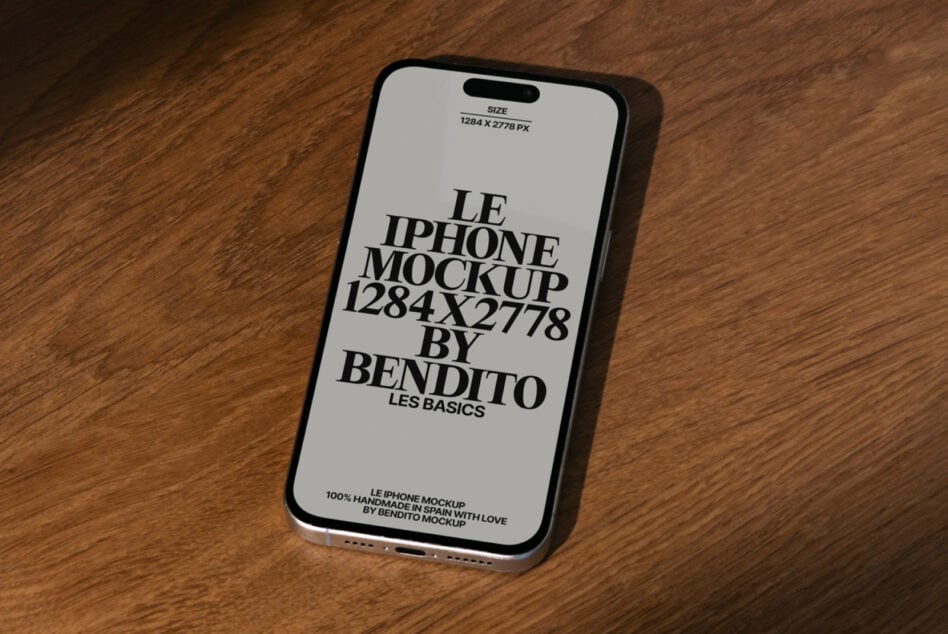 Light gray iPhone mockup with dark text on wooden surface, angled right