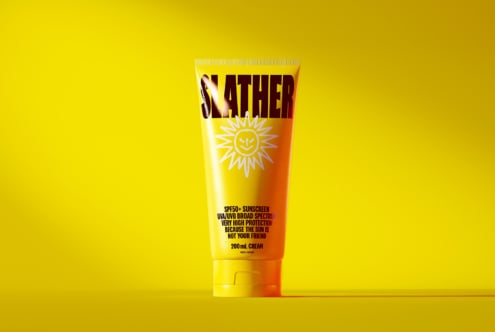 Single sunscreen tube front view with cheerful sun icon on yellow