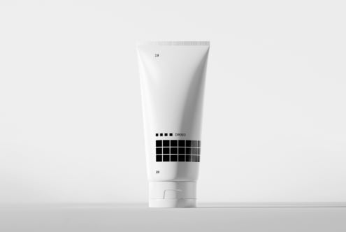 White cosmetic tube with color swatch grid mockup on neutral background