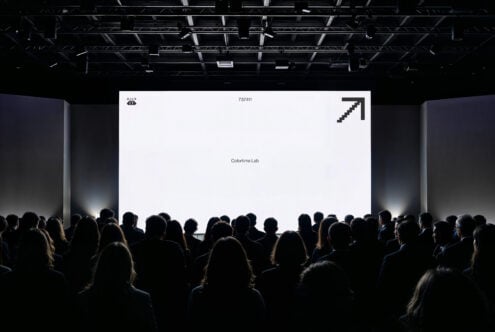 Conference audience viewing a large screen presentation in a dark room. Perfect for mockup templates, digital business graphics, event design assets.