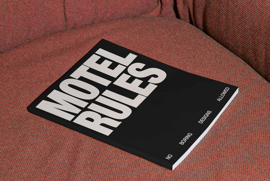 Black magazine mockup with white bold lettering on rust textured fabric