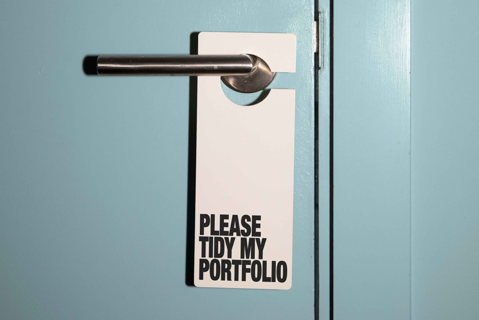 Door hanger tag with do not disturb message on turquoise painted door
