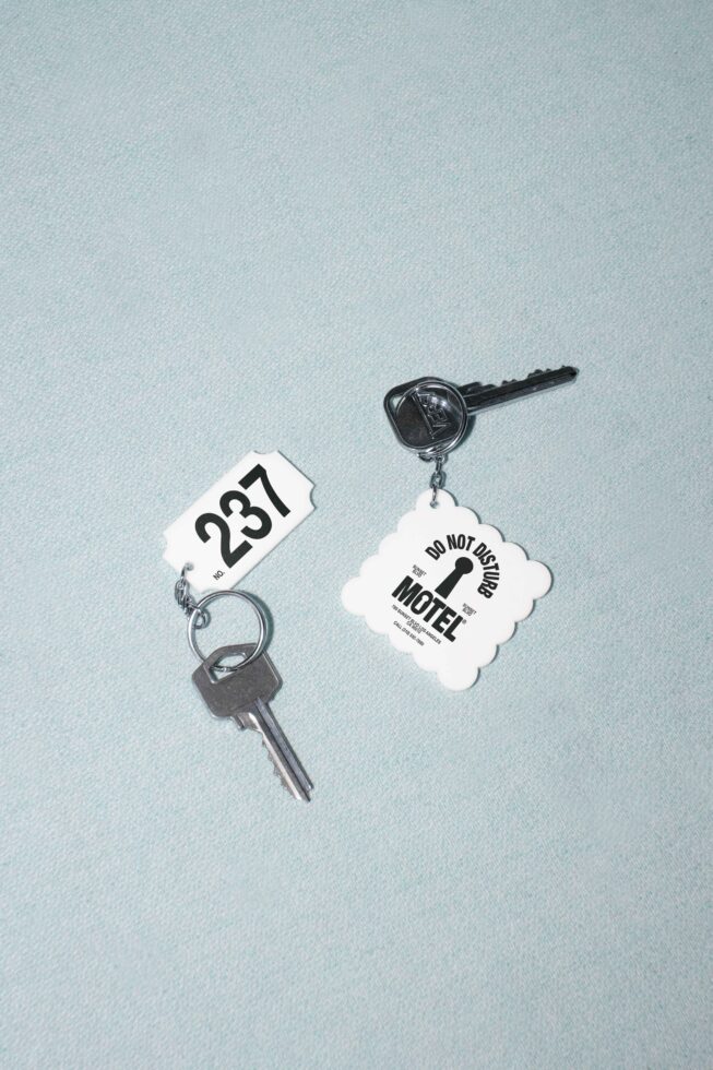 Motel room key with do not disturb tag showing number 287 on mint background