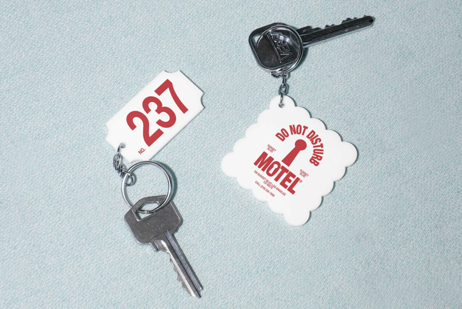 Vintage motel key tags with "do not disturb" message on cloud-shaped tag, styled flat lay