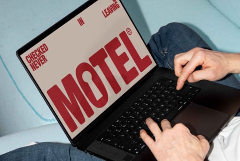 Laptop with retro motel font on screen suitable for graphic design projects. Perfect for designers seeking unique typography templates or mockups.