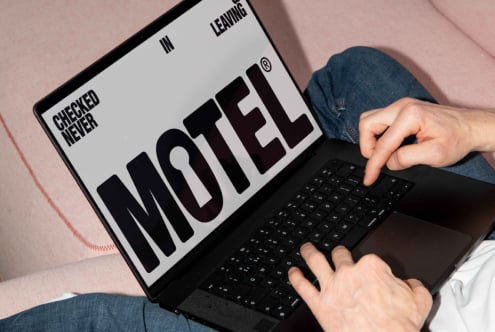 Person typing on laptop with bold MOTEL font on screen modern typography design mockup digital asset for designers creative workspace SEO friendly