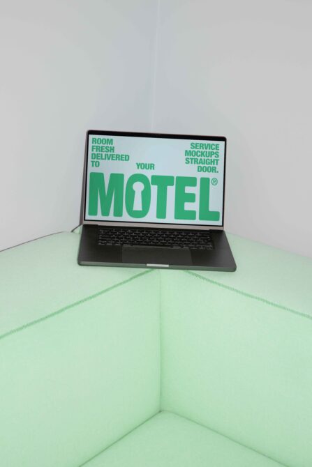 Laptop on mint cushion showing green MOTEL sign with keyhole symbol