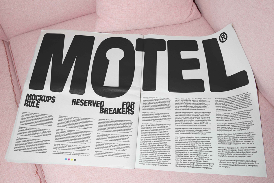 Motel magazine on pink couch with bold typography spread across pages