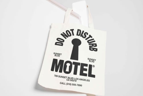 Tote bag mockup with Do Not Disturb Motel design; ideal for branding presentations graphics design and templates. Neutral background enhances focus.