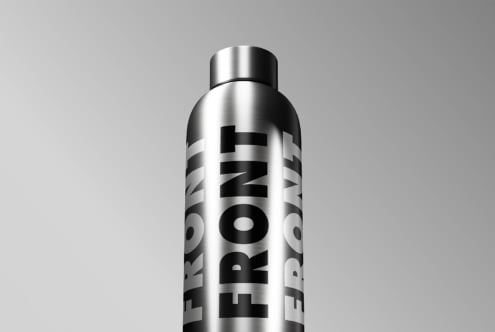 Silver metallic bottle mockup with black vertical letter branding on side