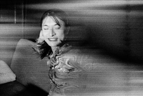 Distorted monochrome image of a person with horizontal lines creating a glitch effect perfect for graphic design templates and vintage retro art projects.