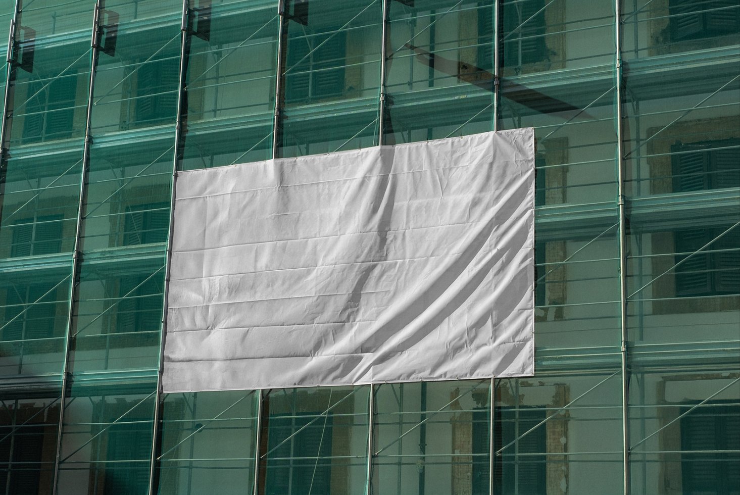 Large blank banner mockup on a glass building facade ideal for urban advertising display design templates architecture marketing materials