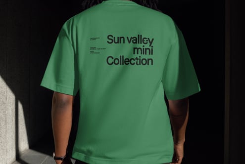 Back view of person wearing green T-shirt with Sun Valley Mini Collection text. Perfect for mockup templates and apparel graphics for designers.