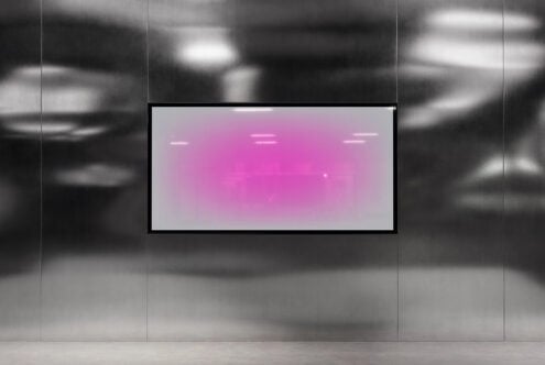 Digital art display with pink gradient on metallic wall background. Suitable for mockup templates and digital graphics. Perfect for designers.