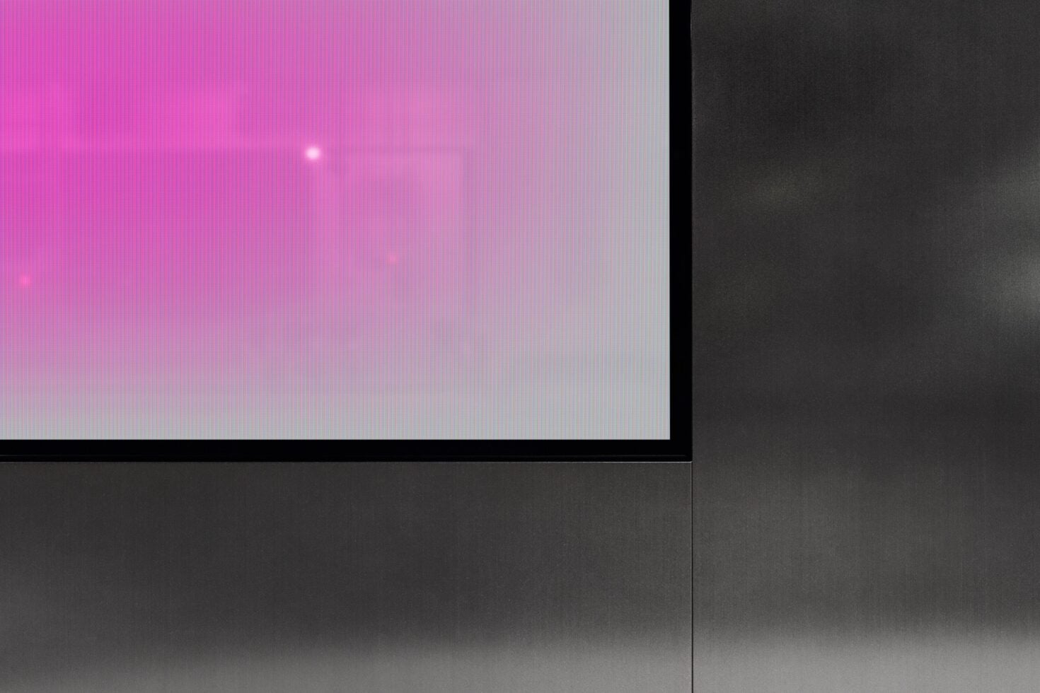 Pink gradient screen transitioning to white with soft glow on dark backdrop