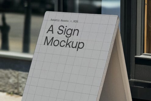 Outdoor sign mockup with grid design displayed on a sidewalk. Ideal for showcasing branding graphics and templates. Perfect for graphic designers.