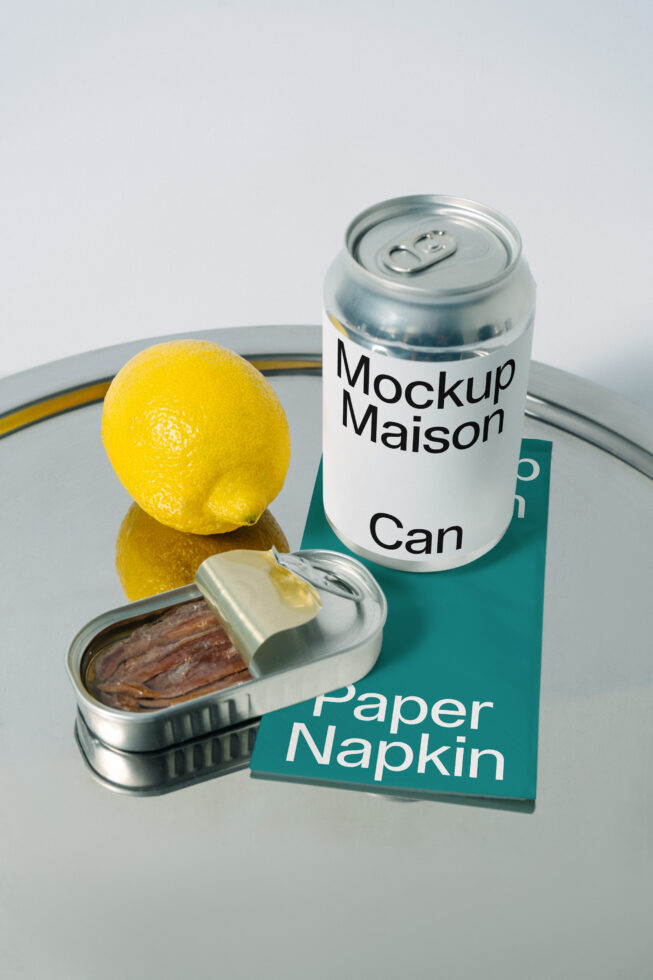 Tin can mockup with sardine can, lemon, paper napkin on reflective tray. Realistic product display ideal for designers. Keywords: mockup, design, template.