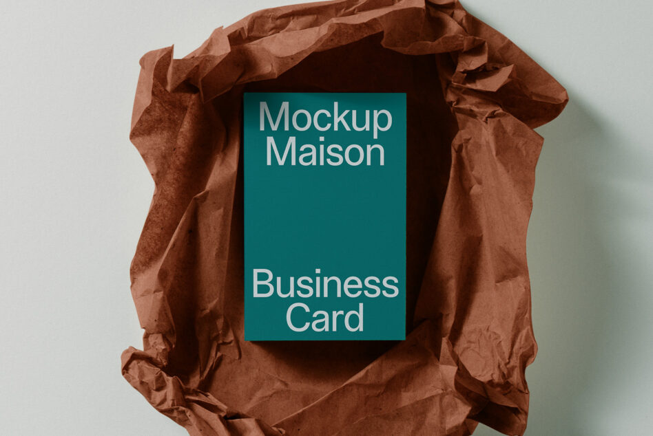 Teal business card mockup wrapped in crumpled rust-colored tissue paper