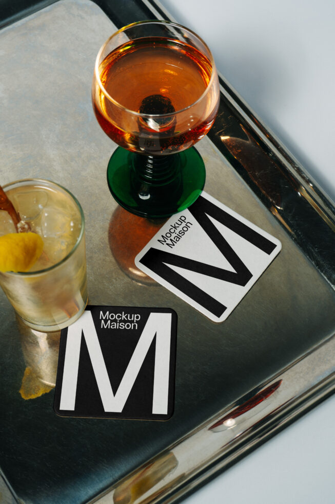 Drink coasters mockup on metal tray with cocktail glasses top view drink accessories branding template for designers graphic design asset elegant setup