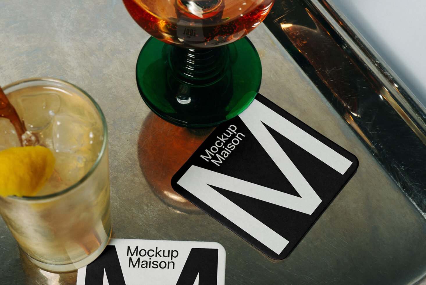 Coaster mockup on a metal table with drinks. Perfect for designers seeking realistic beverage presentation. Ideal for branding and product showcase.