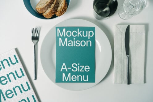 Top view of A-size menu mockup on a plate with cutlery and bread; ideal for restaurant branding template, menu design, and graphic presentation.