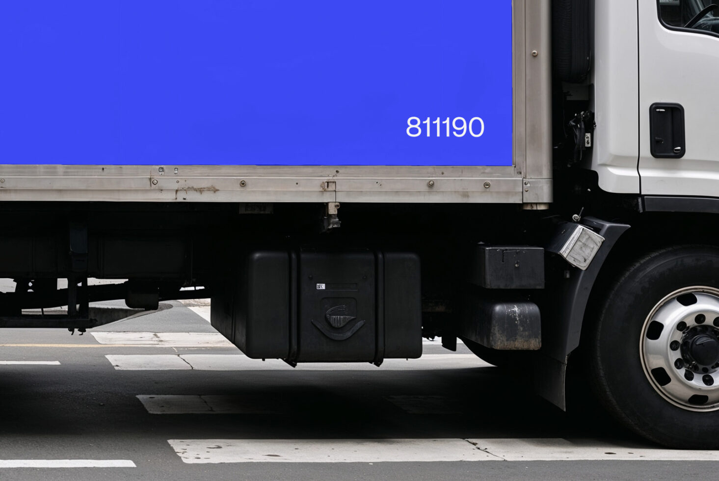Side view of a delivery truck with blank blue cargo area for design mockups. Perfect for graphic designers needing transportation-themed templates.