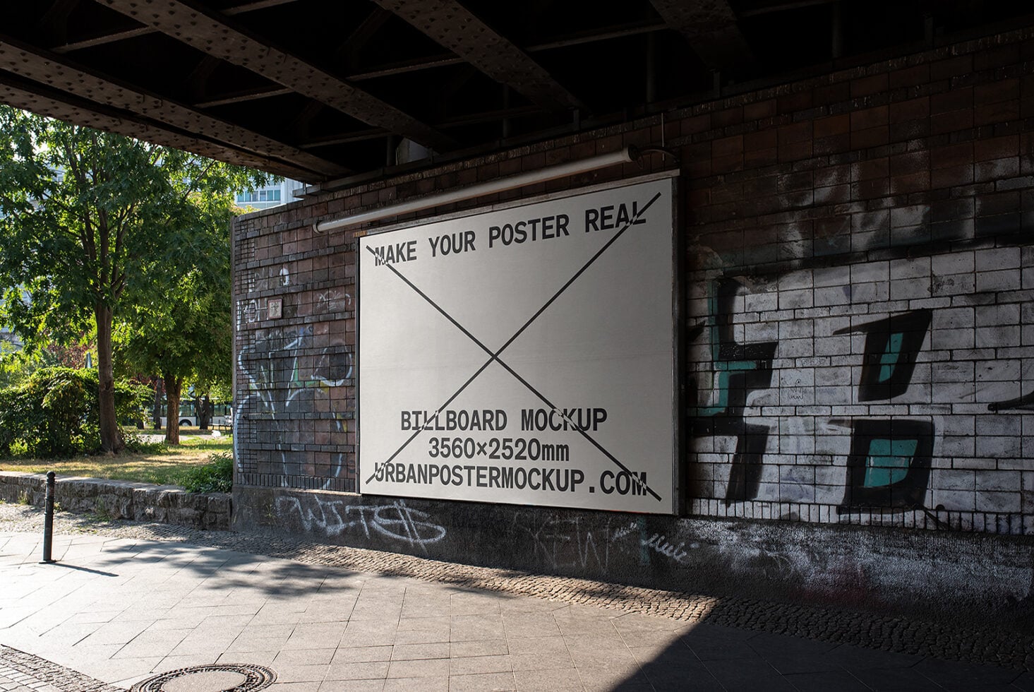 Large outdoor billboard under bridge in daylight with brick wall backdrop