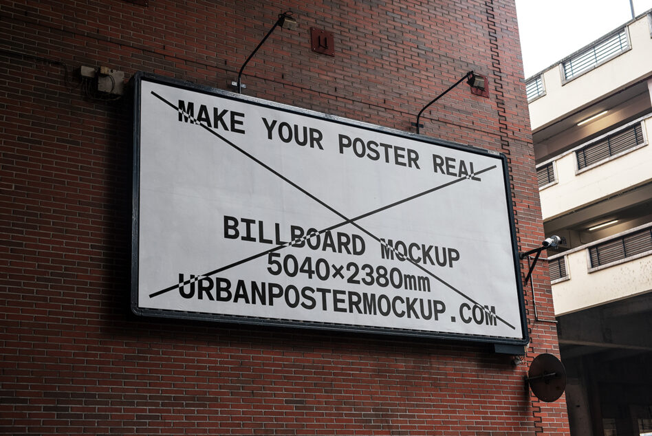 Large billboard on brick building displaying sample poster design mockup text