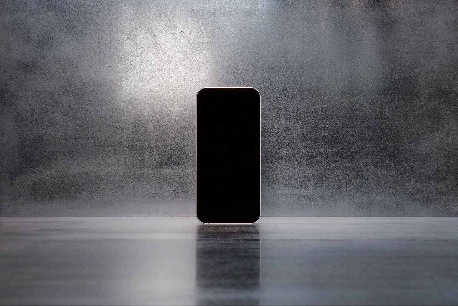Minimalist smartphone mockup standing on reflective surface with textured gray background. Perfect for showcasing apps. Keywords: Mockup Design Template.